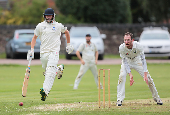 Bollington Captain Rick Hough makes his ground while Chris Moors waits for the ball