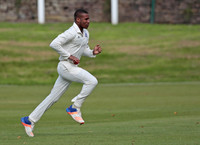 Bollington fast bowler Dario Searle runs in